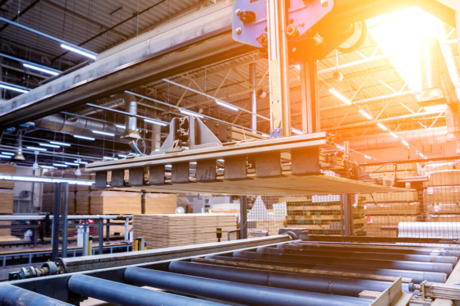 Production line of the wooden floor factory. CNC automatic woodworking machine. Industrial background